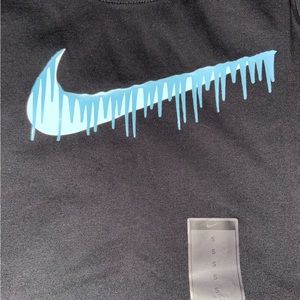 a brand new black nike shirt with a dripping nike sign